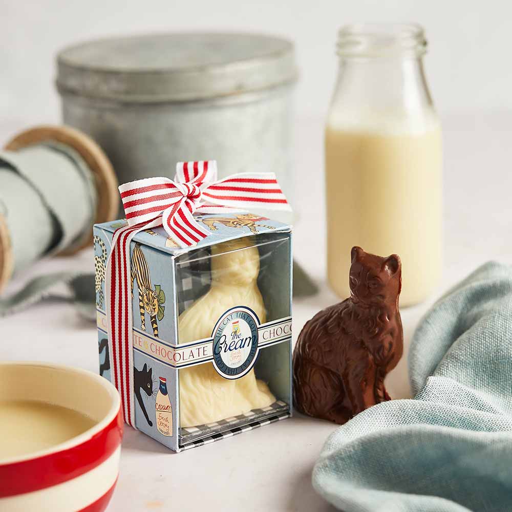 Cat That Got the Cream white chocolate cat in a gift box beside a milk chocolate cat