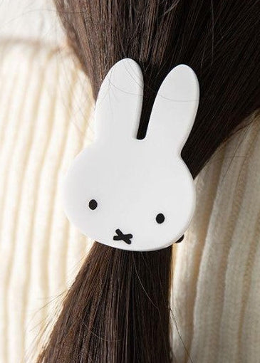 White Miffy hair tie holding a ponytail