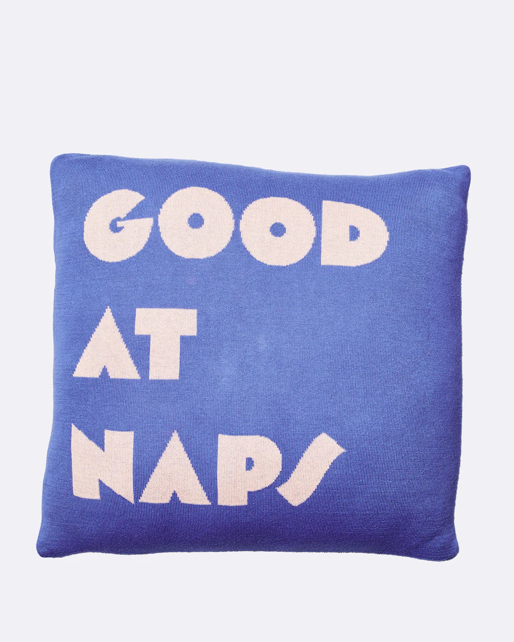 Blue cushion with 'Good at naps' in pale pink letters