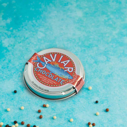 Chocolate caviar tin on blue