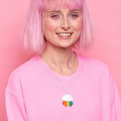 Smiling woman with pink hair wearing the cloud necklace
