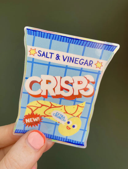 Naomi Wilkinson sticker of a packet of salt & vinegar crisps with a smiling crisp, held in a hand