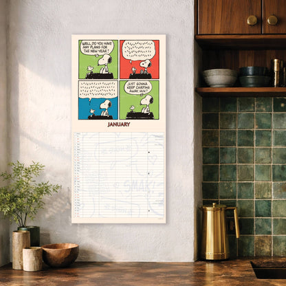 Peanuts family calendar hanging on a kitchen wall