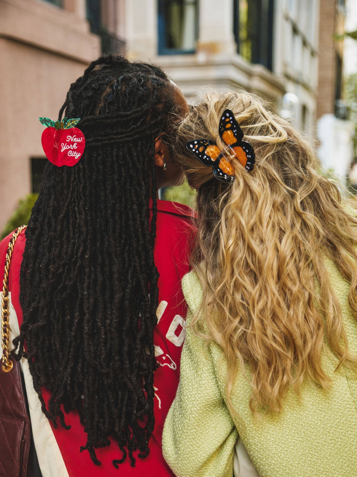 Two friends from behind wearing hair clips