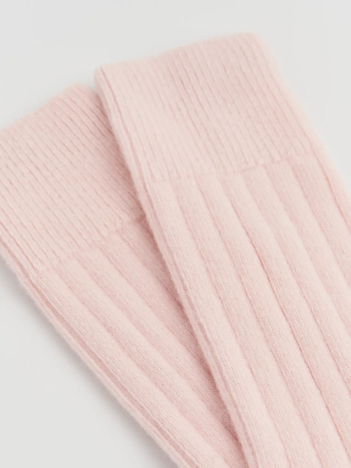 Close-up of the ribbed frosting pink merino knit