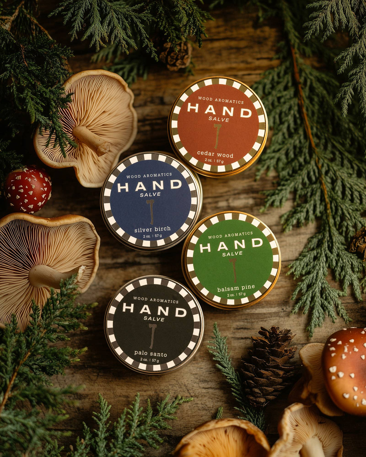 Kalastyle hand salve tins among pine and mushrooms