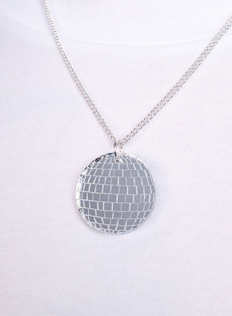Disco ball pendant on a silver chain, close-up