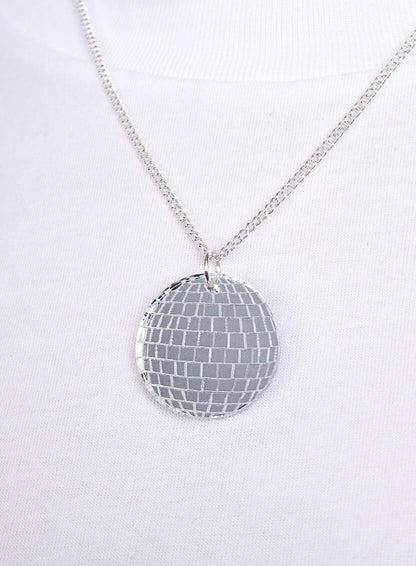 Disco ball pendant on a silver chain, close-up