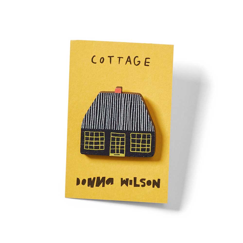 Cottage pin badge on its card