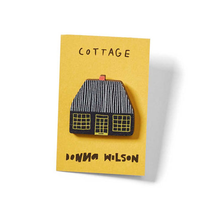 Cottage pin badge on its card