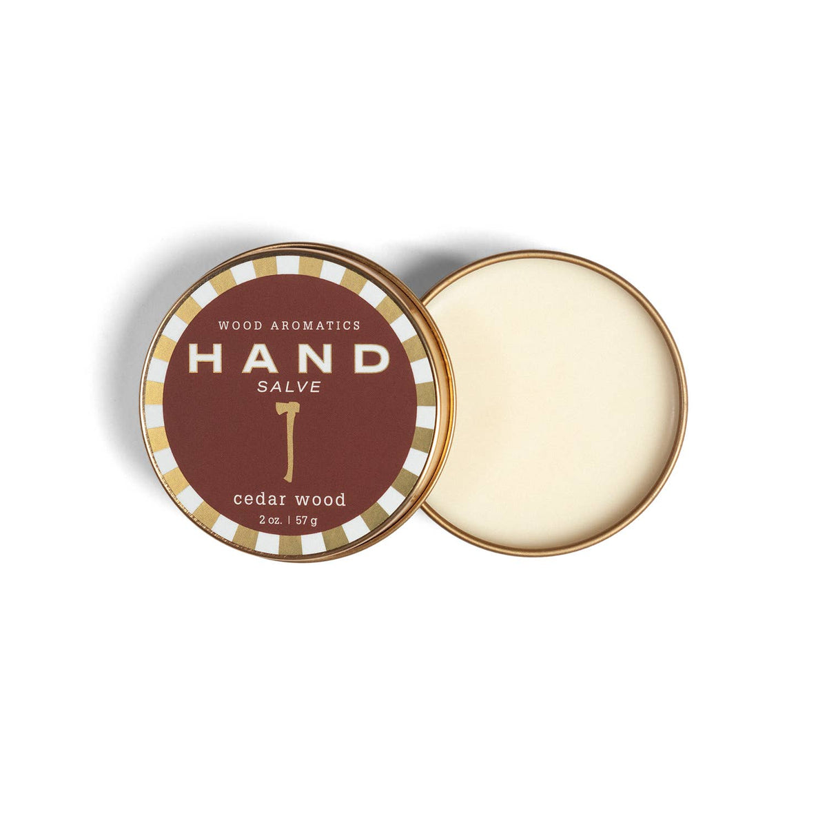 Open tin of cedar wood hand salve beside its lid