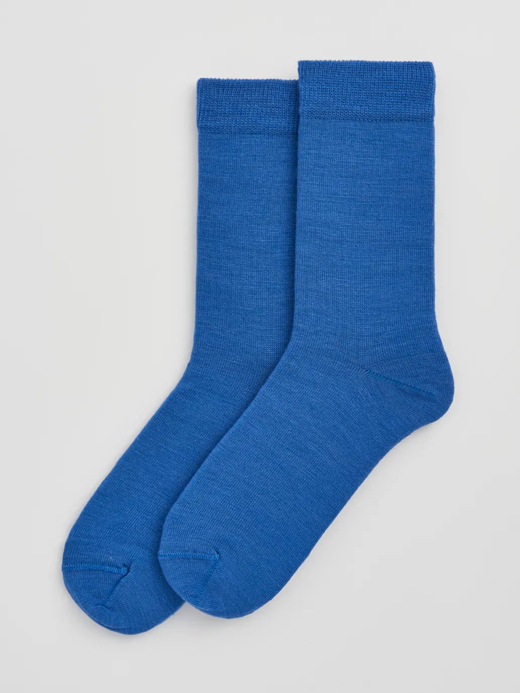 Pair of strong blue calf-length merino socks laid flat