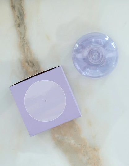 Botanica lavender translucent glass incense holder beside its lilac box