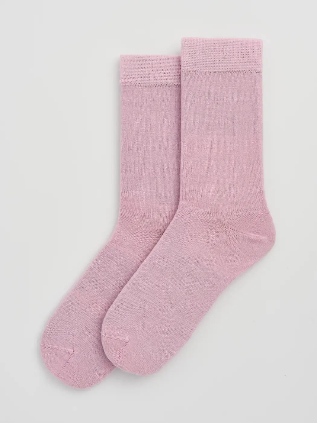 Pair of sugar pink calf-length merino socks laid flat