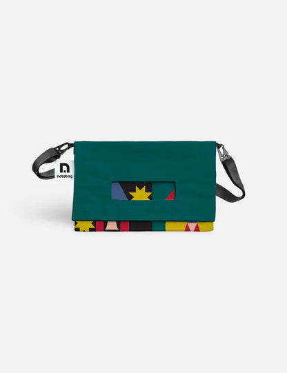 Back of the Notabag Playground crossbody bag in dark green with a strip of the print