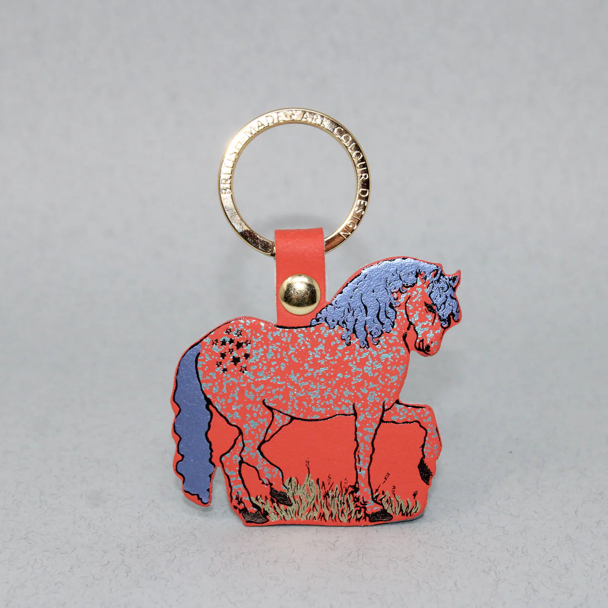 Coral leather horse key fob with a blue mane on a gold ring