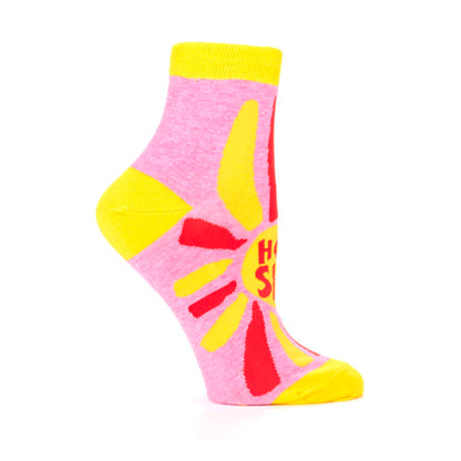 Side view of a pink Hot shit ankle sock with a yellow heel