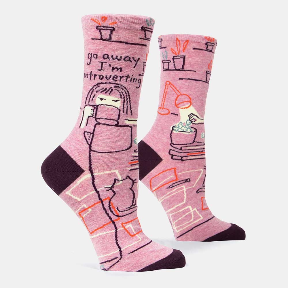 Pink socks with a woman reading among plants and a cat: Go away, I'm introverting
