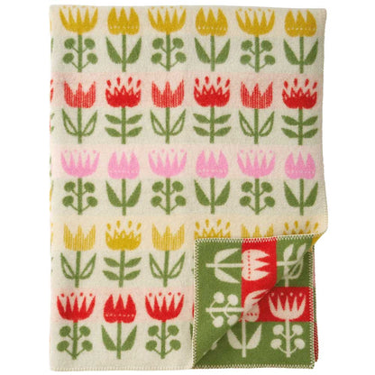 Folded tulip blanket showing the green and red edging