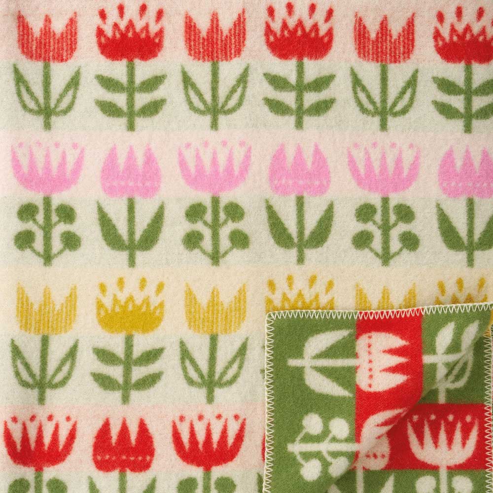 Cream lambswool blanket with rows of red, pink and yellow tulips and a green border