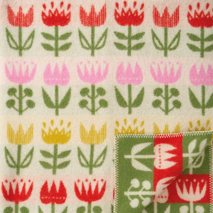 Cream lambswool blanket with rows of red, pink and yellow tulips and a green border