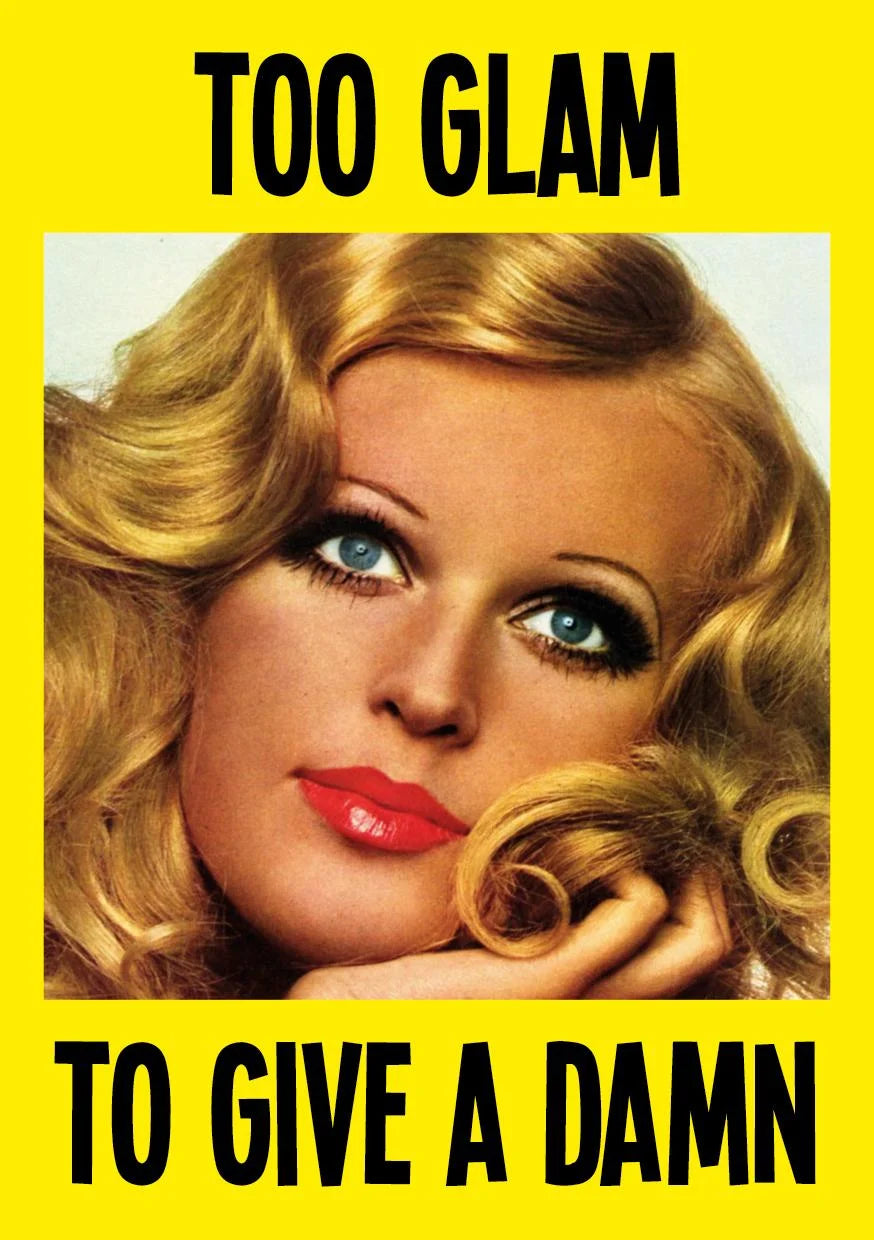 Kiss Me Kwik card: a glamorous 1970s woman with golden curls between the words 'Too glam to give a damn' on yellow