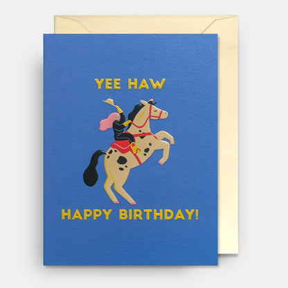 Lagom mini card: a cowgirl on a rearing horse, with gold 'Yee haw – Happy birthday!' on blue