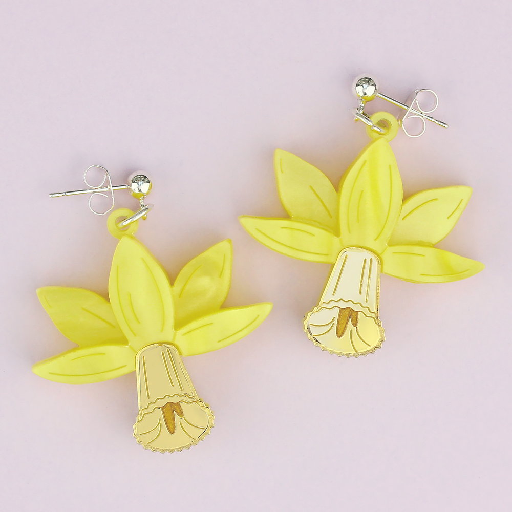 Yellow acrylic daffodil drop earrings on silver studs