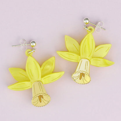 Yellow acrylic daffodil drop earrings on silver studs