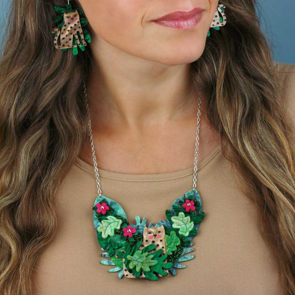Woman wearing the doodle leopard necklace with matching earrings