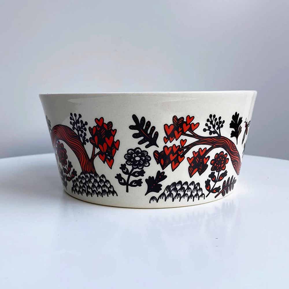 Outside of the red bird bowl with flowers