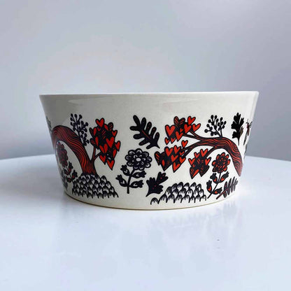 Outside of the red bird bowl with flowers
