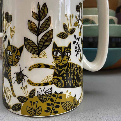 Close-up of the cats and plants on the jug
