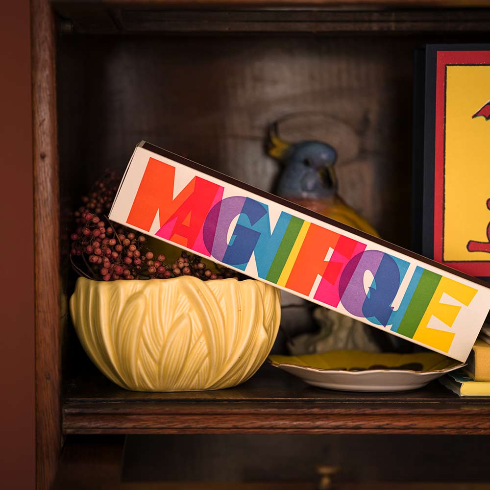 Magnifique matches on a shelf beside a yellow bowl