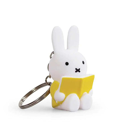 White Miffy figure keyring holding a yellow book