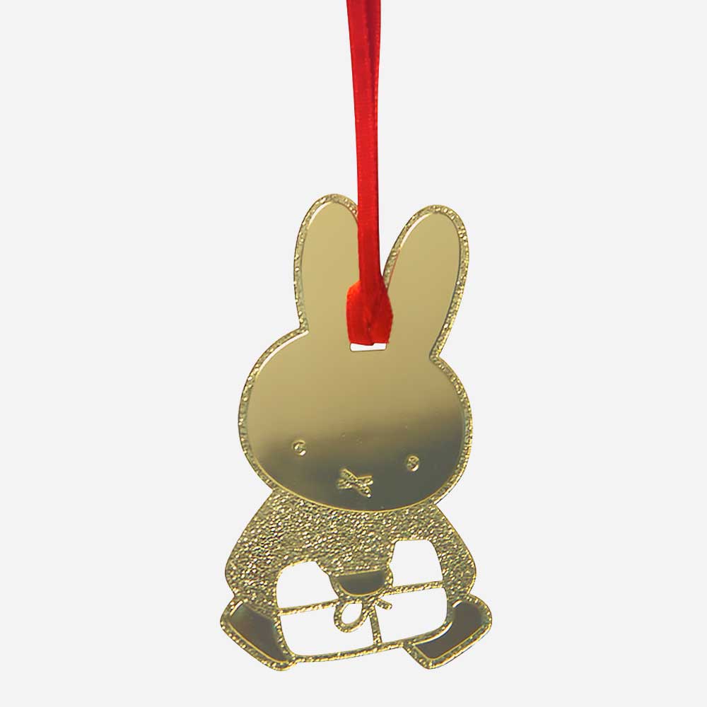 Gold Miffy Christmas decoration: Miffy holding a gift, on a red ribbon