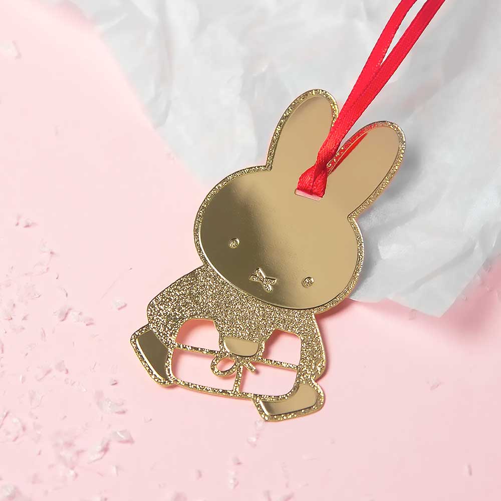 Gold Miffy with a gift decoration on pink tissue paper