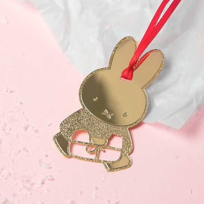 Gold Miffy with a gift decoration on pink tissue paper