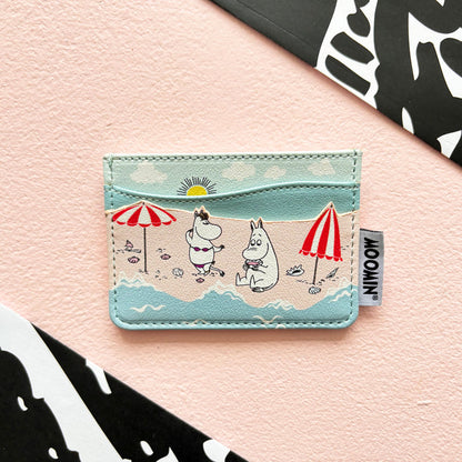 Moomin card holder printed with Moomins on a beach under red and white parasols