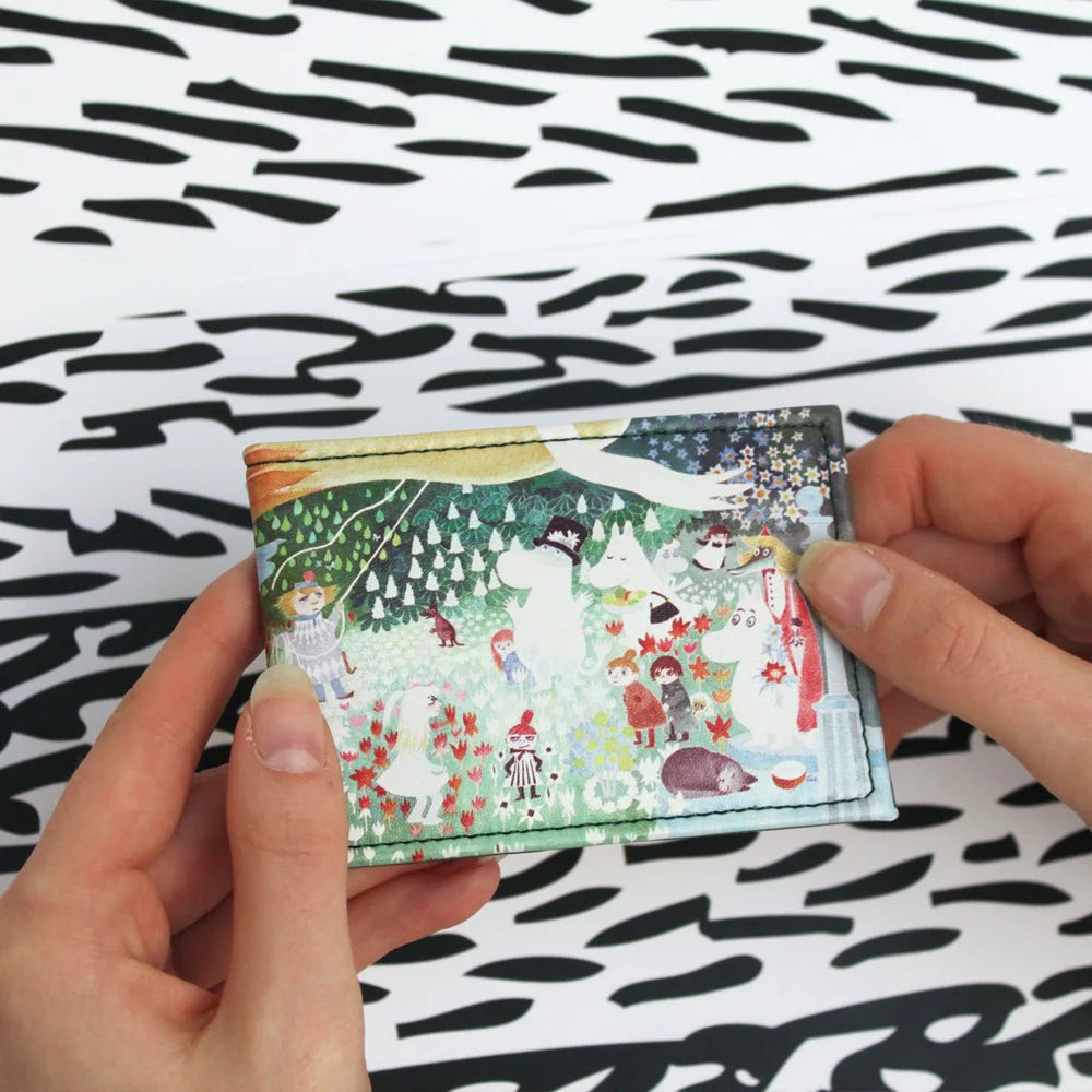 Hands opening the Dangerous Journey travel pass holder
