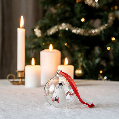 Moomin garland bauble on a table with candles and a Christmas tree