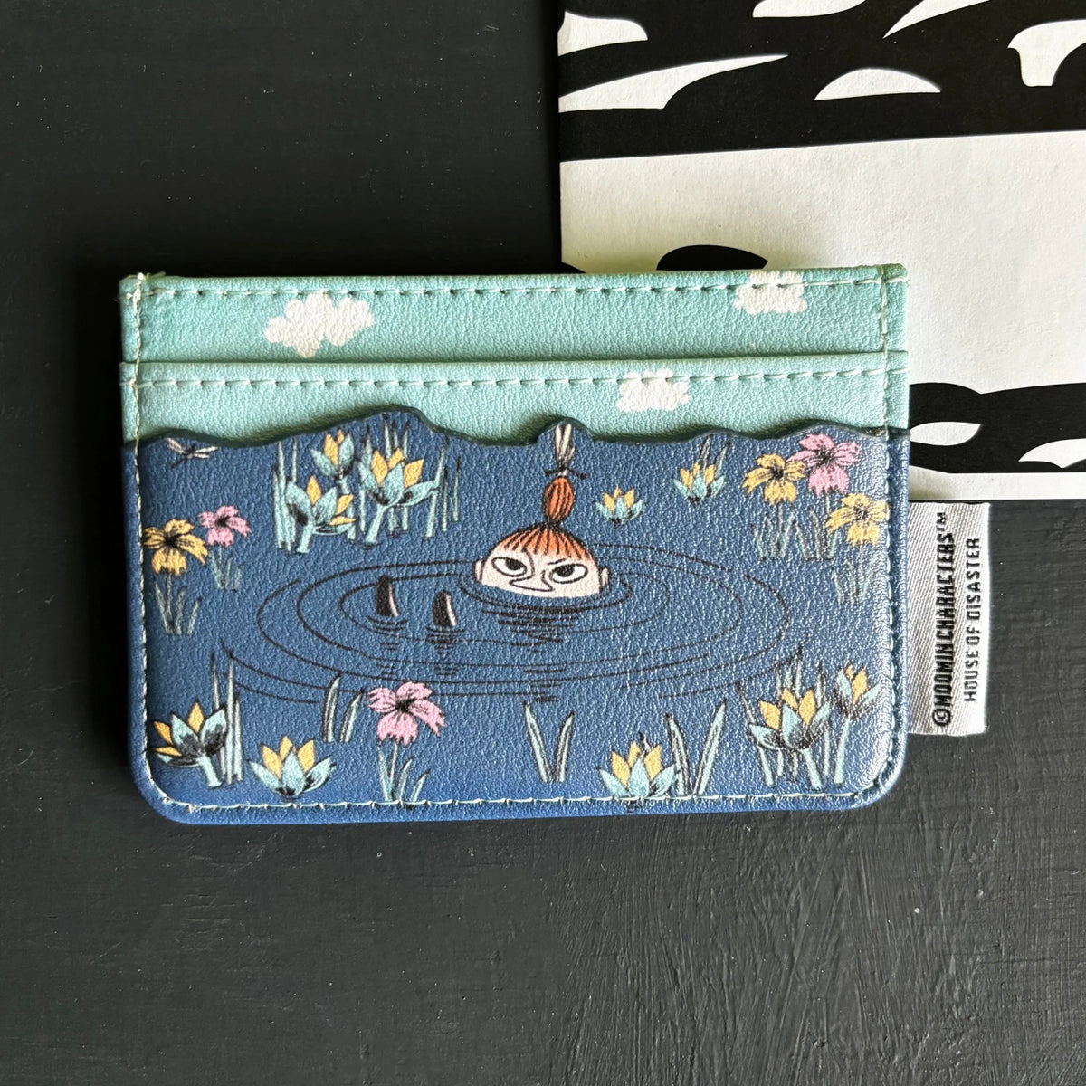 Back of the lotus card holder with Little My swimming in a pond