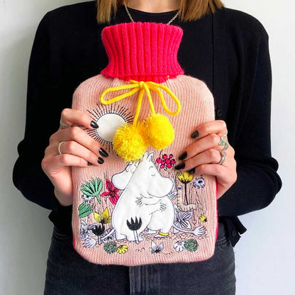 Person holding the pink Moomin Love hot water bottle