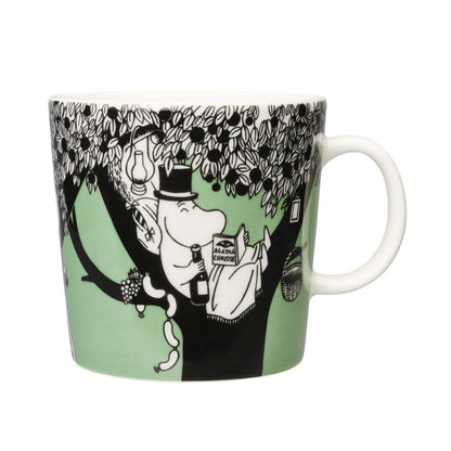 Green Moomin mug with Moominpappa reading in a tree