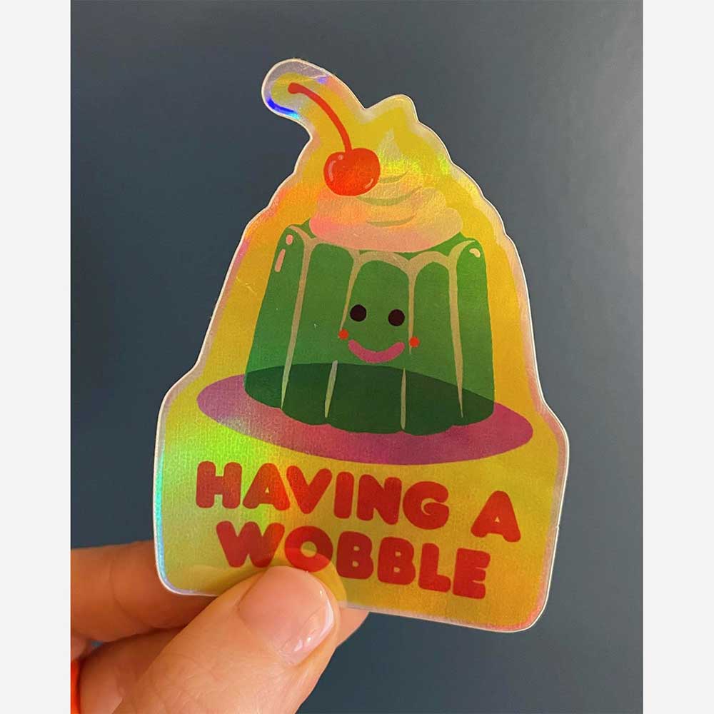 Having a Wobble sticker held in a hand