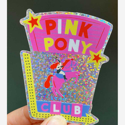 Pink Pony Club sticker held in a hand
