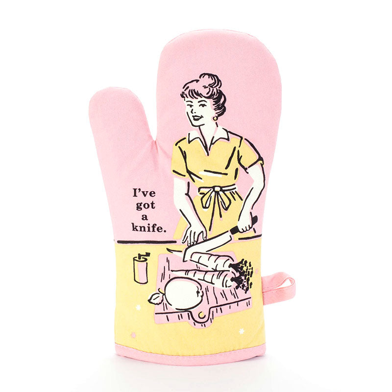 Pink and yellow oven mitt with a woman carving a roast: I've got a knife.