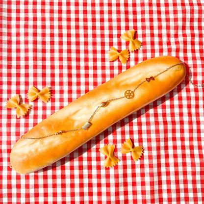 Pasta shape necklace draped over a baguette