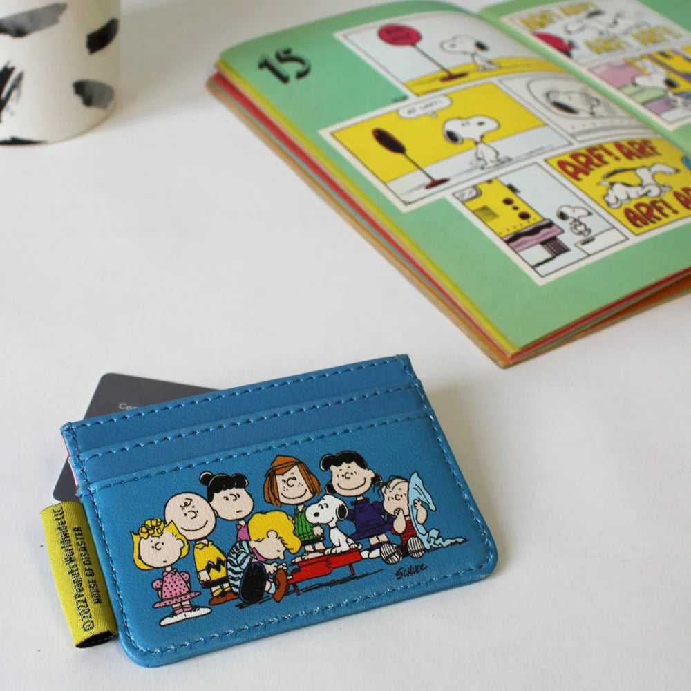 Blue Peanuts card holder with the gang on the front, on a comic book