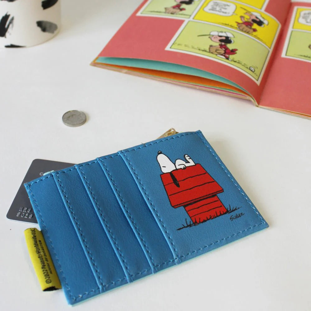 Back of the purse in blue with card slots and Snoopy on his doghouse